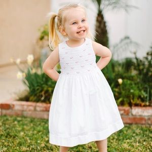 Vintage Kru Little smocked top dress with embroidered flowers and tie back.